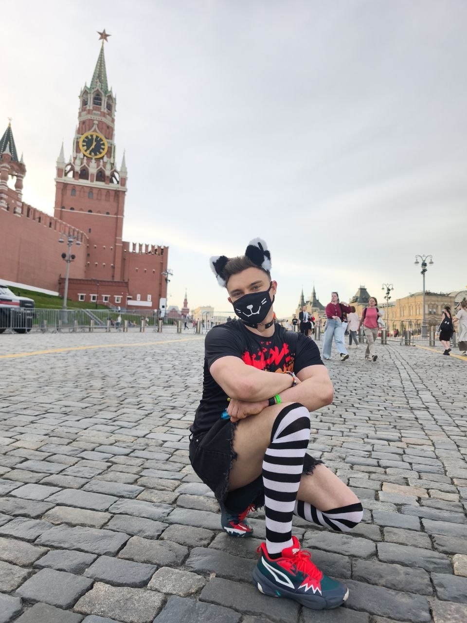 Daniil wearing cat ears and a mask on Red Square